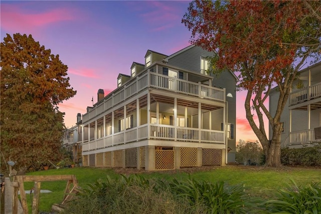 exterior space featuring a balcony and a yard