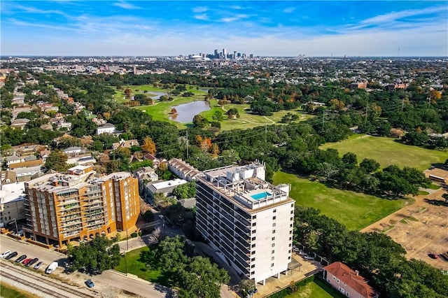 aerial view featuring a water view, view of golf course, and a city view