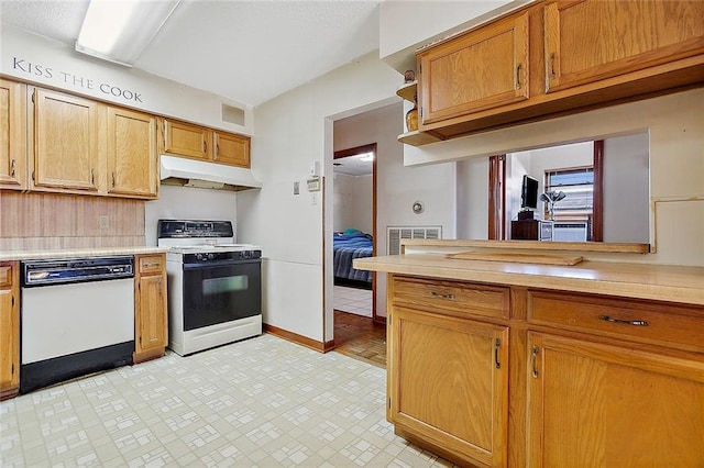 kitchen featuring white appliances and light tile floors