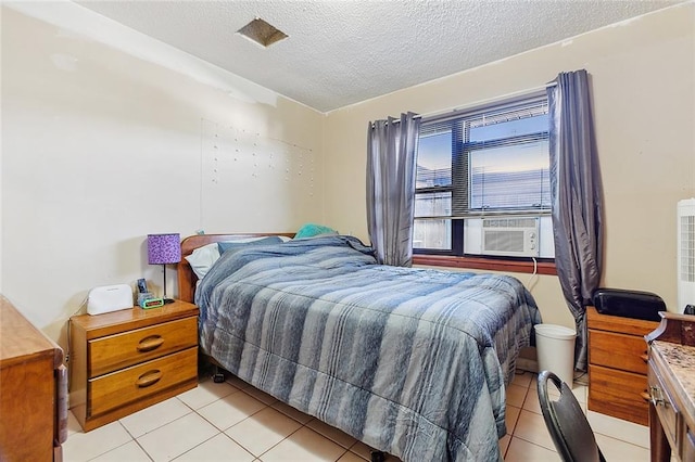 bedroom featuring a textured ceiling and light tile floors