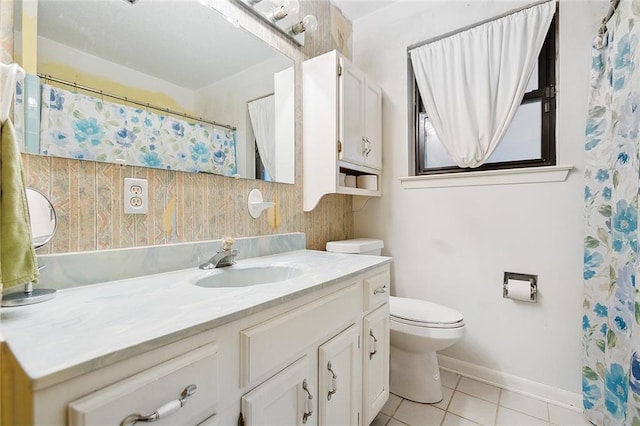 bathroom featuring toilet, tile floors, and vanity