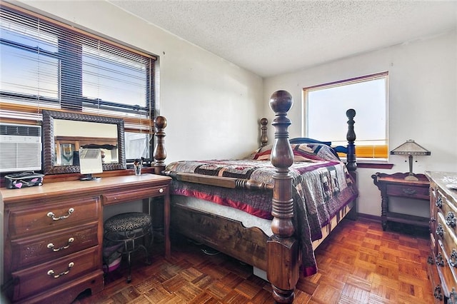 bedroom with dark parquet floors and a textured ceiling