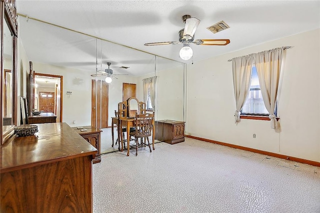 office space with ceiling fan and light colored carpet