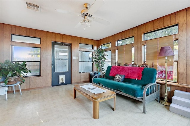 sunroom / solarium featuring ceiling fan and a healthy amount of sunlight