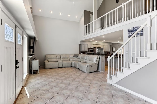 tiled living room with a towering ceiling