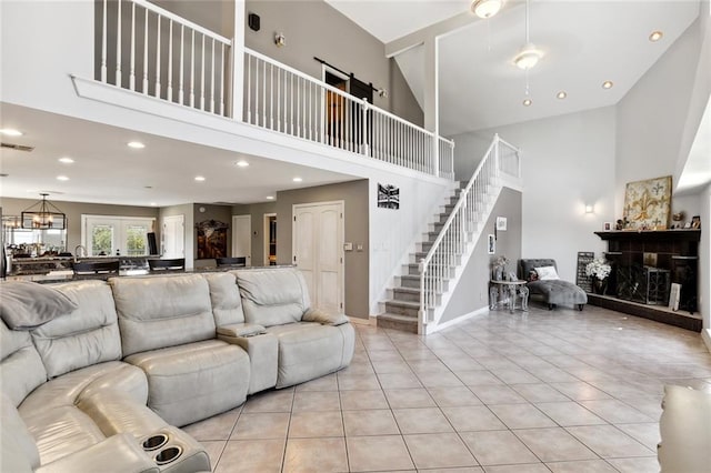 living room with light tile patterned flooring and high vaulted ceiling