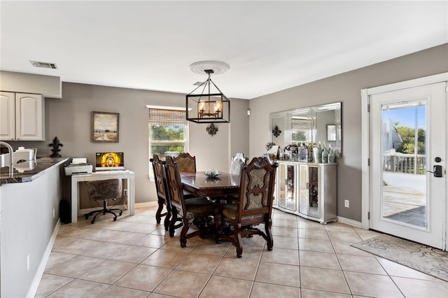 tiled dining space with an inviting chandelier and a wealth of natural light