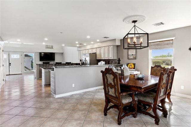 dining area featuring a chandelier and light tile patterned floors