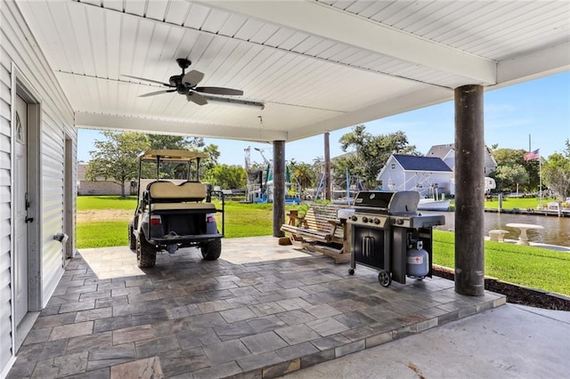 view of patio featuring a water view, ceiling fan, and area for grilling