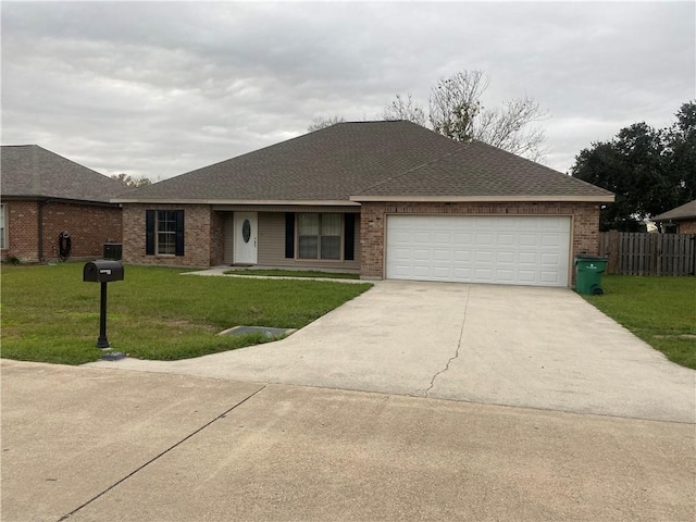 ranch-style house featuring a front yard and a garage