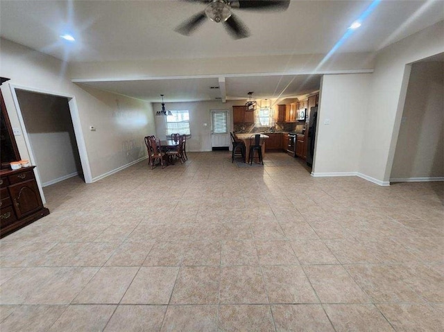 living room with ceiling fan with notable chandelier and light tile patterned floors