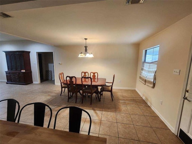 tiled dining area featuring a notable chandelier