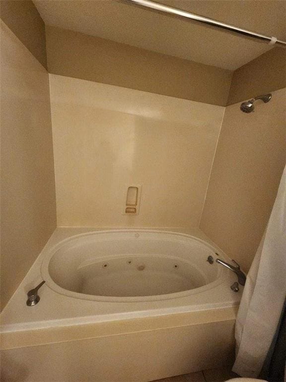 bathroom with shower / tub combo with curtain