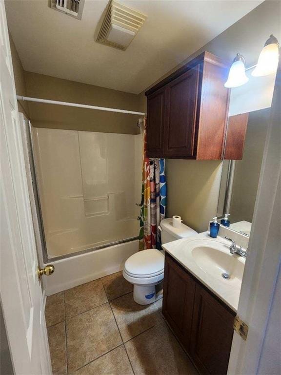 full bathroom featuring tile patterned floors, vanity, shower / tub combo with curtain, and toilet