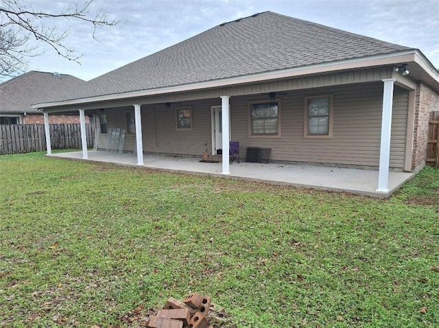 rear view of property with a yard and a patio