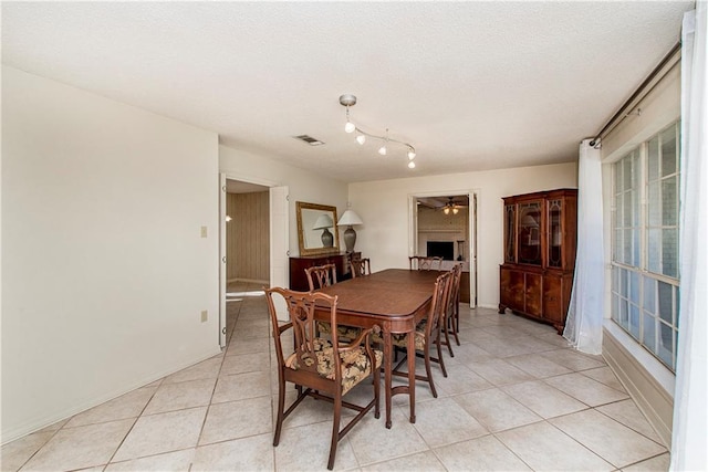 tiled dining room with ceiling fan