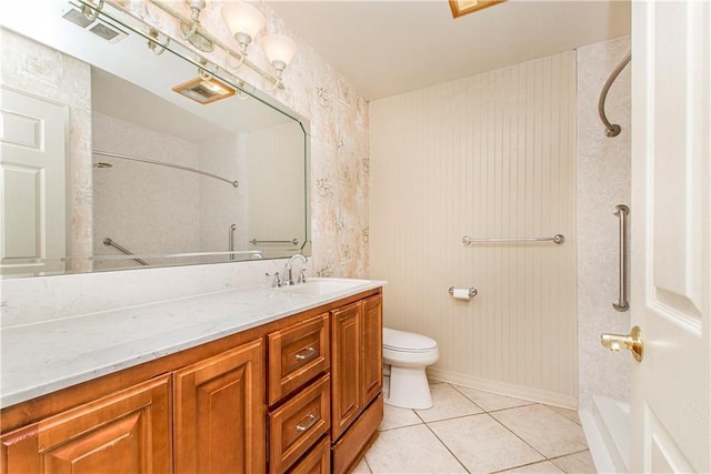 bathroom featuring tile patterned flooring, vanity, and toilet