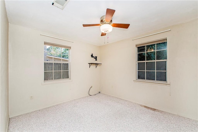 carpeted spare room with ceiling fan