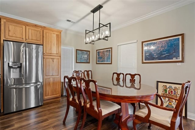 dining space featuring ornamental molding and dark wood-type flooring