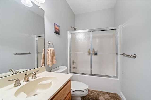 full bathroom featuring vanity, toilet, and combined bath / shower with glass door