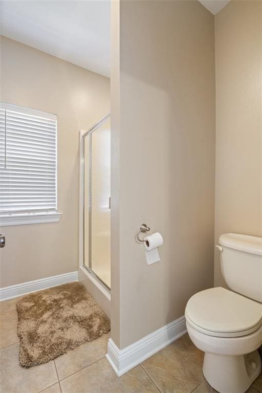 bathroom with tile patterned flooring, an enclosed shower, and toilet