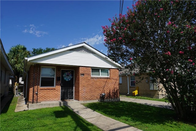 bungalow-style home featuring a front yard