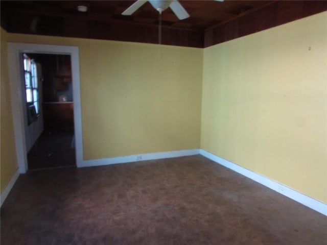 unfurnished room featuring dark carpet and ceiling fan