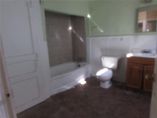 full bathroom featuring toilet, tiled shower / bath combo, and vanity