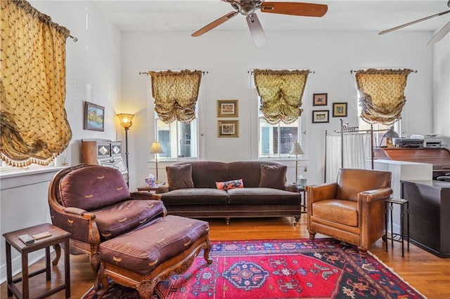 living area with ceiling fan and wood-type flooring