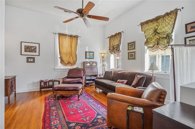 living area featuring hardwood / wood-style flooring and ceiling fan