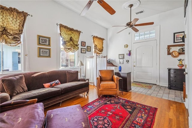 living room with ceiling fan and light wood-type flooring