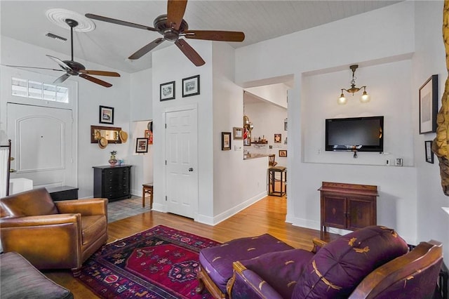 living room with lofted ceiling, light hardwood / wood-style flooring, and ceiling fan