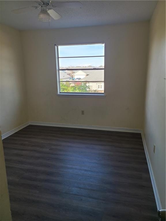 unfurnished room featuring ceiling fan and dark hardwood / wood-style floors