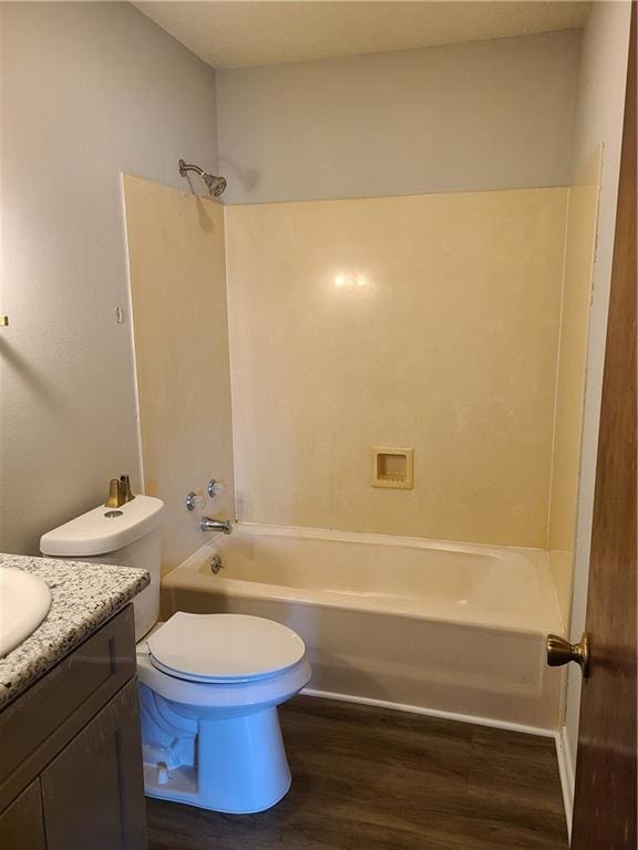 full bathroom featuring toilet, vanity, hardwood / wood-style floors, and shower / bathtub combination