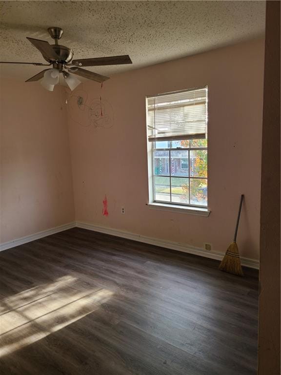 unfurnished room with dark hardwood / wood-style flooring, ceiling fan, and a textured ceiling