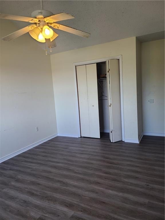 unfurnished bedroom with a closet, ceiling fan, and dark hardwood / wood-style floors