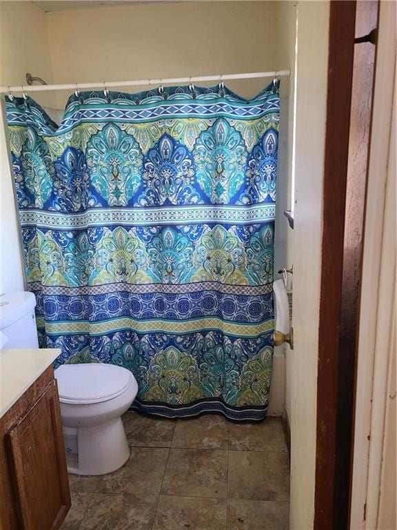 bathroom with vanity, toilet, and tile flooring