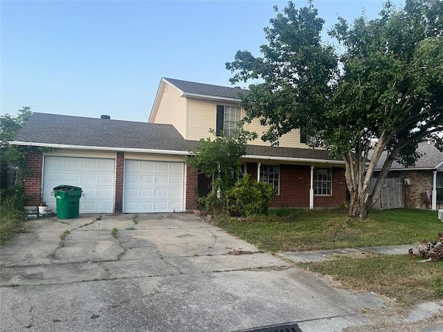 view of property featuring a front lawn and a garage