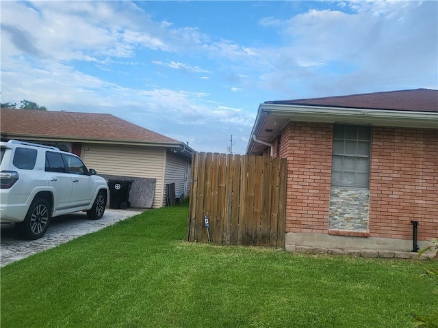 view of side of property with a lawn