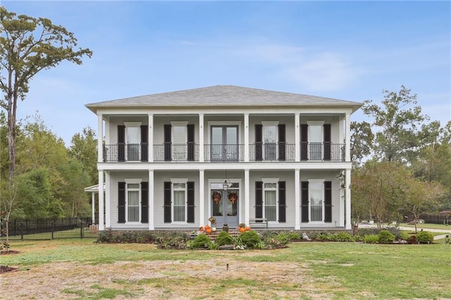 view of front of property with a front yard and a balcony