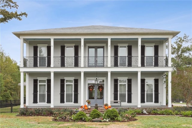 view of front of house featuring a front lawn, a porch, and a balcony