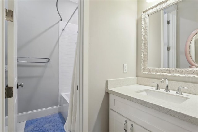 bathroom with shower / tub combo with curtain and vanity