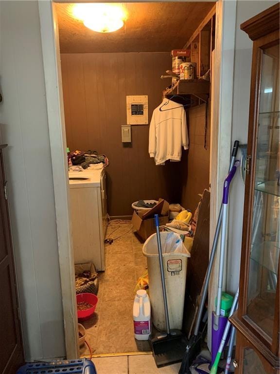 5978 Perryman Ln, Osyka, MS 39657 - washroom featuring washer / dryer, wooden walls, light tile patterned floors, and laundry area