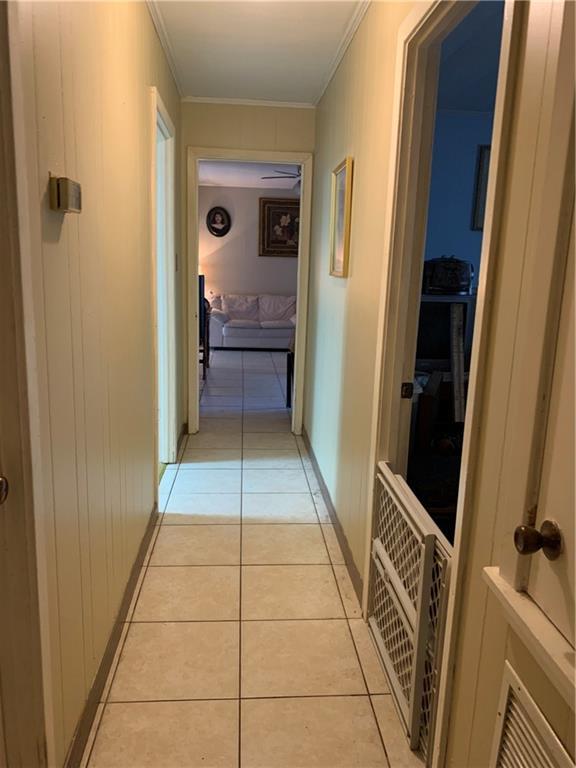 5978 Perryman Ln, Osyka, MS 39657 - corridor featuring light tile patterned flooring, crown molding, and baseboards
