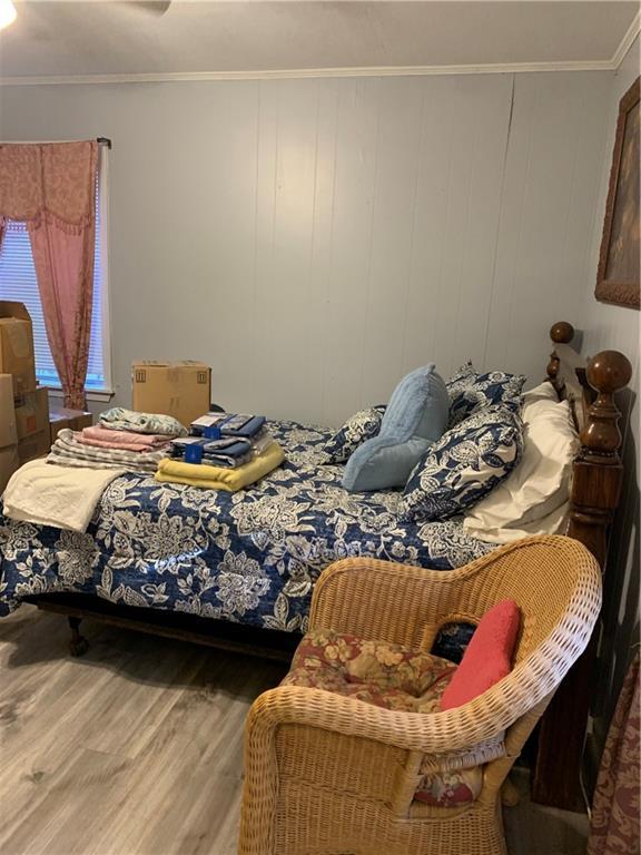 5978 Perryman Ln, Osyka, MS 39657 - bedroom with crown molding and wood finished floors