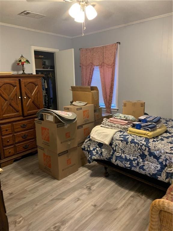 5978 Perryman Ln, Osyka, MS 39657 - bedroom with a walk in closet, a closet, visible vents, and light wood-type flooring