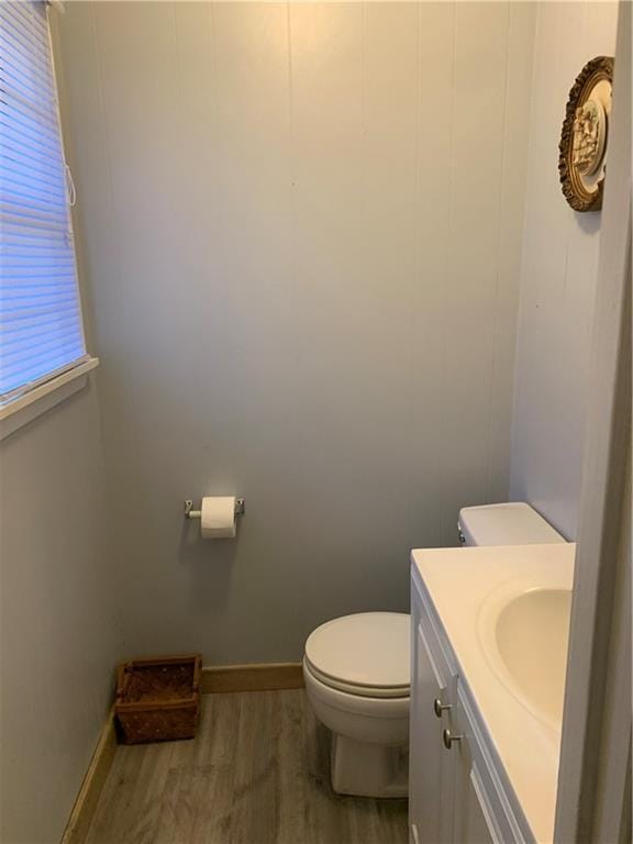 5978 Perryman Ln, Osyka, MS 39657 - half bath featuring baseboards, wood finished floors, vanity, and toilet