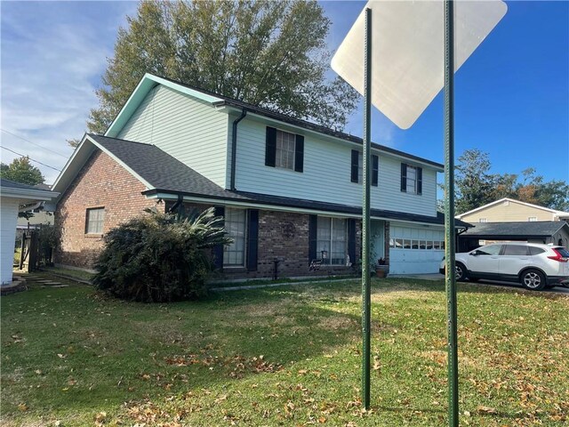 view of front property with a front yard and a garage