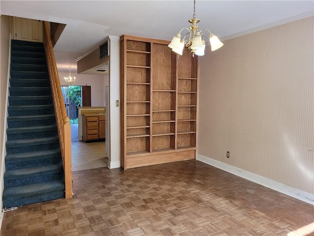 unfurnished room with a notable chandelier and dark parquet flooring