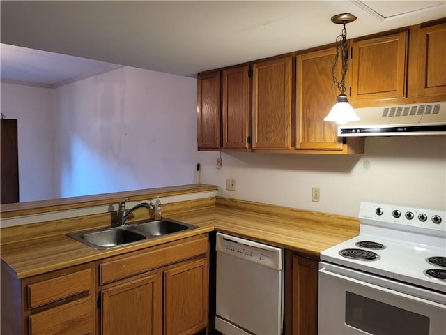 kitchen featuring pendant lighting, sink, and white appliances